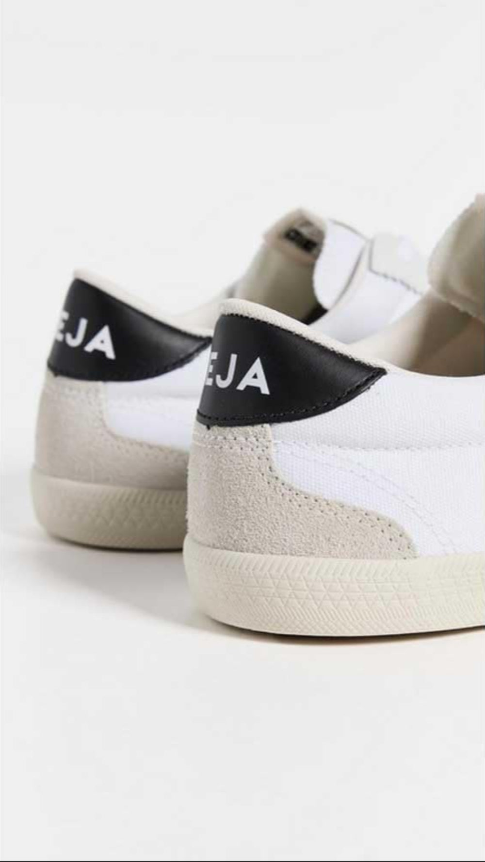 White sneakers with black accents on a white background