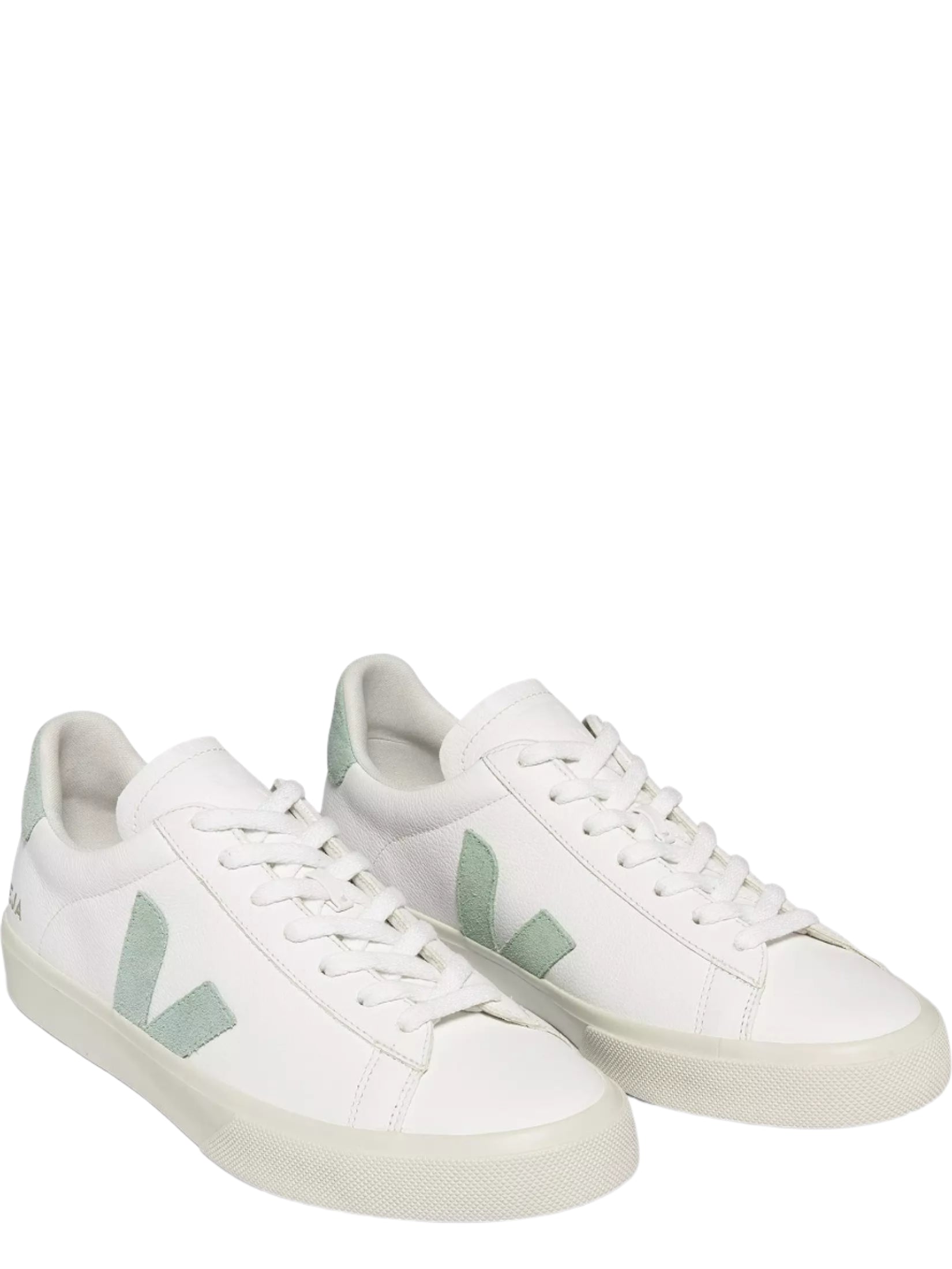 White sneakers with green accents on a white background