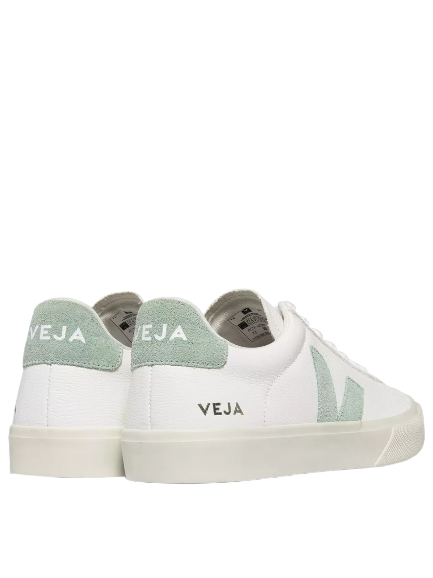 White sneakers with green accents and 'Veja' branding on a white background