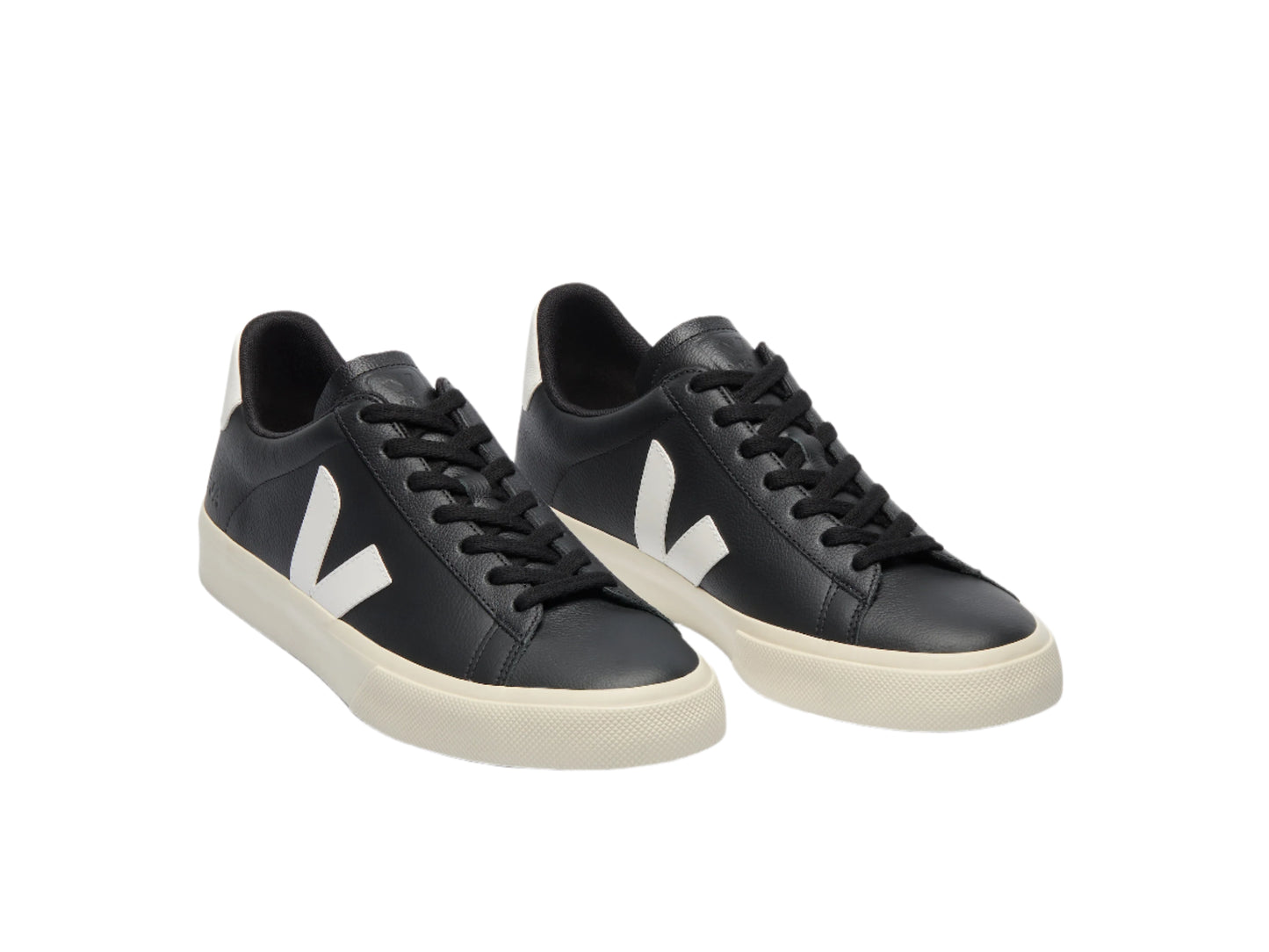 Pair of black sneakers with white accents on a light gray background