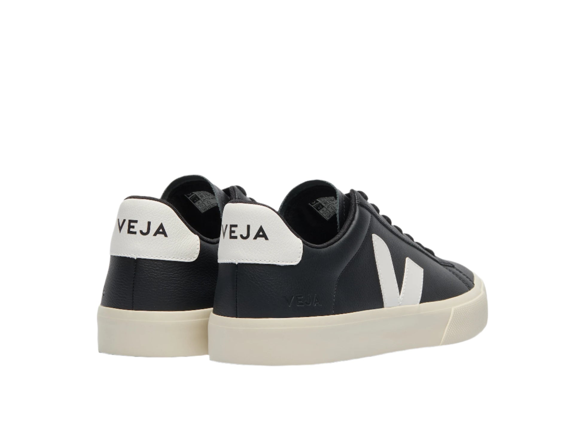 Black and white sneakers with 'Veja' branding on a light gray background