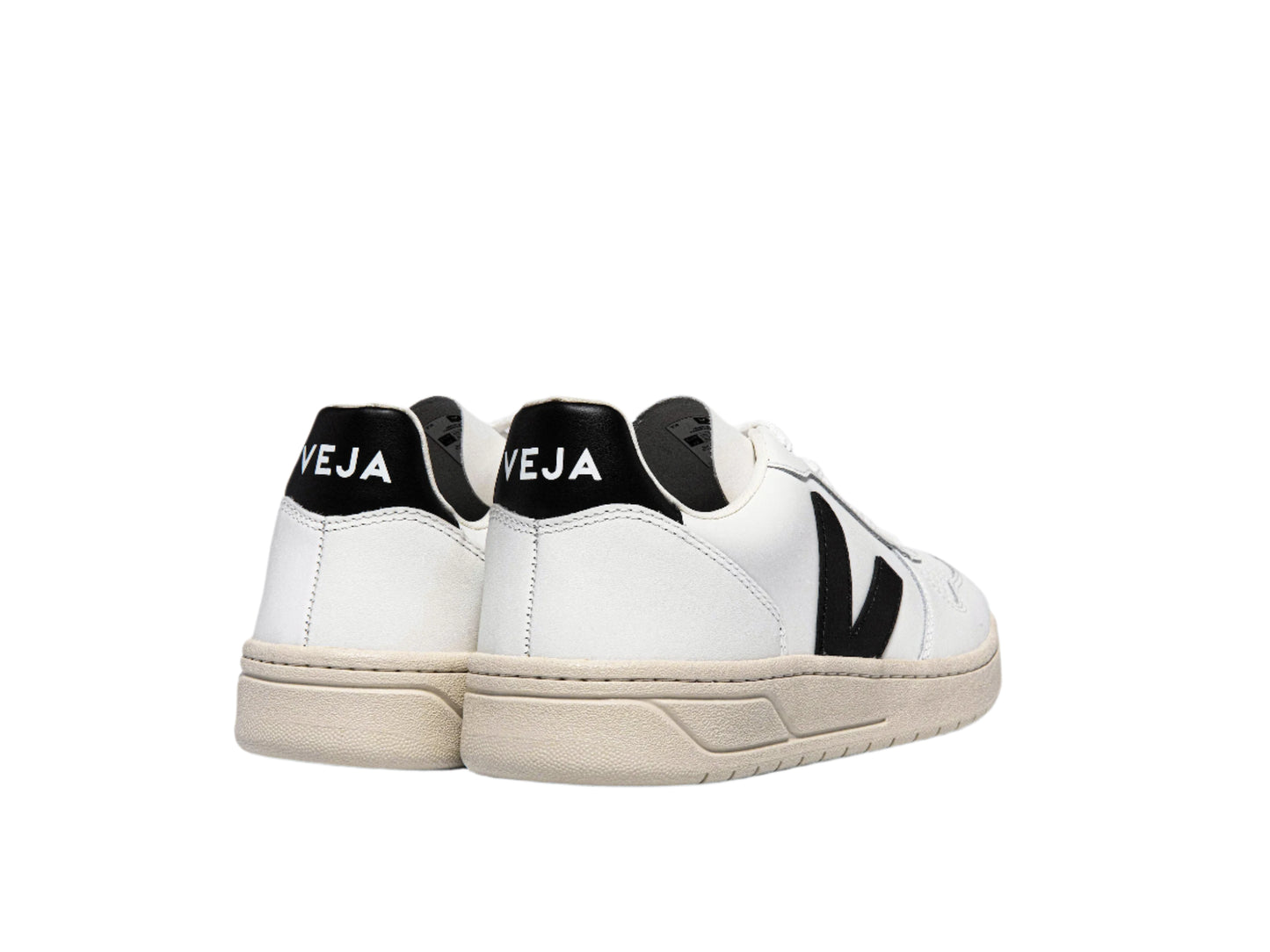 White sneakers with black accents and 'Veja' branding on a white background