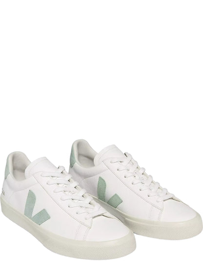 White sneakers with green accents on a white background