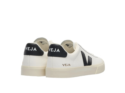 White sneakers with black accents and 'VEJA' branding on a white background
